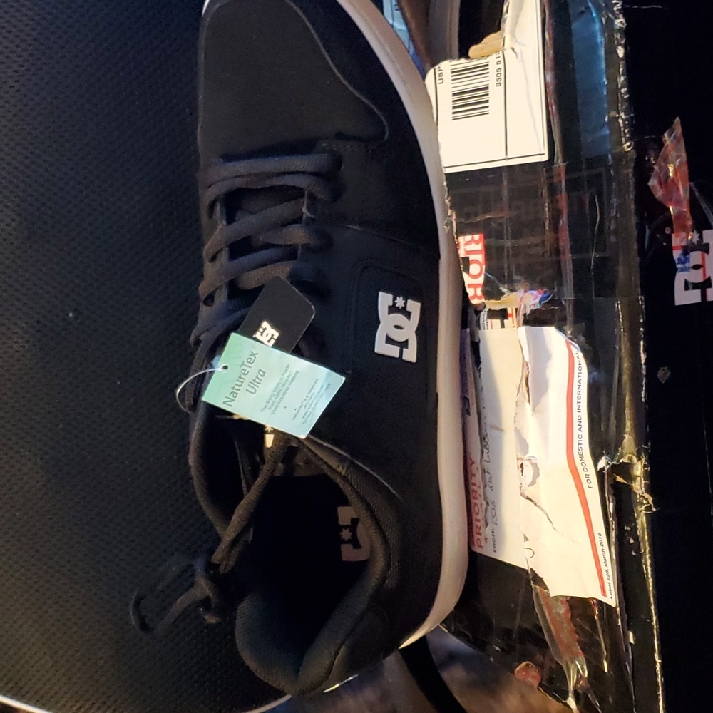 DC men's brand new never worn size 13 shoes black with white trim.